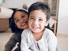Dos mellizos felices jugando en casa.